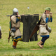 Serfs carrying J.Law’s Golden Globes gown to the fashion closet or a historical reenactment of the battle of Hastings on its 950th anniversary? YOU DECIDE. Image via Getty